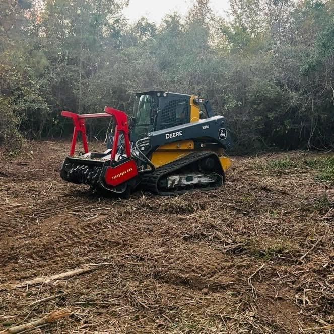 Forestry mulcher attachment on a compact track loader clearing dense brush